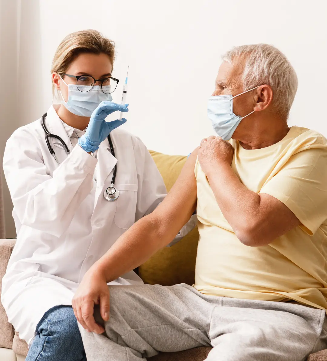 Registered nurse giving injection service at home in Dhaka to an elderly patient